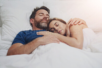 Buy stock photo Relax, cuddle and couple with sleeping in bed for marriage, commitment or comfort in rest at home. Partner, love and man with embrace of woman in house for dreaming, tired or afternoon nap on weekend