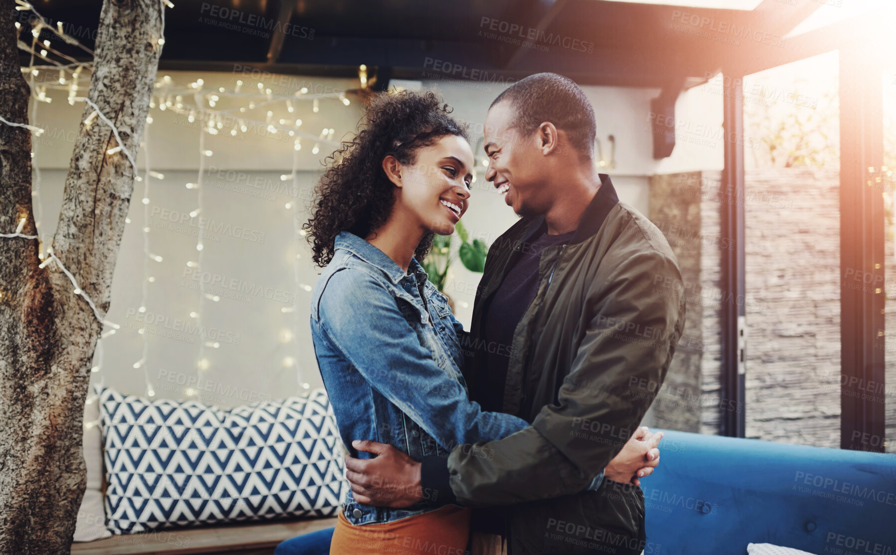 Buy stock photo Happy, couple and love with hug in backyard for marriage, connection and date on anniversary. Man, woman and smile with embrace on patio by fairy lights for support, summer romance and commitment