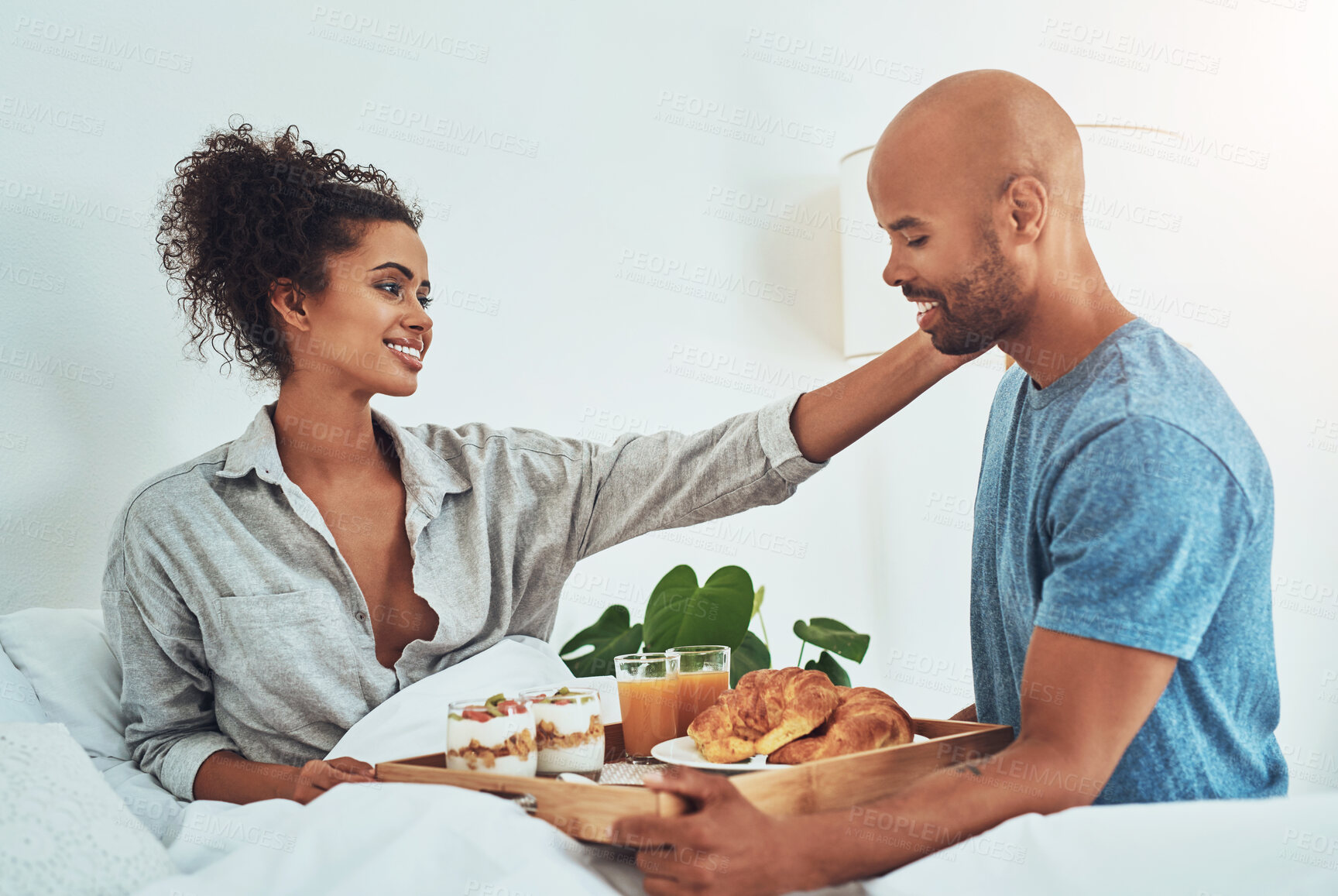 Buy stock photo Breakfast, bed and couple in morning for love, romantic gesture and anniversary celebration. Marriage, valentines day and man and woman with food in home for bonding, relationship and commitment