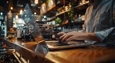 Hands, laptop and phone with coffee shop manager at counter to process online order for small business. Computer, ecommerce and typing with owner in startup cafe for online research or review