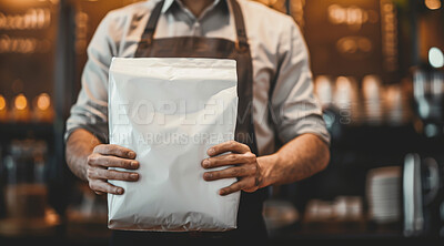 Apron, paper bag and hands of barista in cafe for caffeine, premium espresso blend or roast. Packaging, coffee beans and employee with ingredient for hot beverage, latte or aroma in restaurant