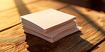 Sticky notes, stack and pile with paper on wooden table for schedule planning, agenda or reminder. Closeup of empty cards or documents for memory, memo or message on checklist, tips or blank pages