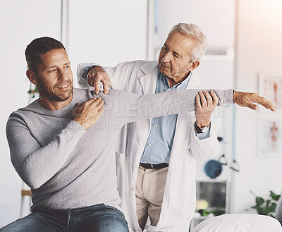 Buy stock photo Doctor, man and patient with stretching for shoulder pain with physical therapy, examination or body recovery. Orthopedic, physician or medical expert for arm rehabilitation with healthcare or advice