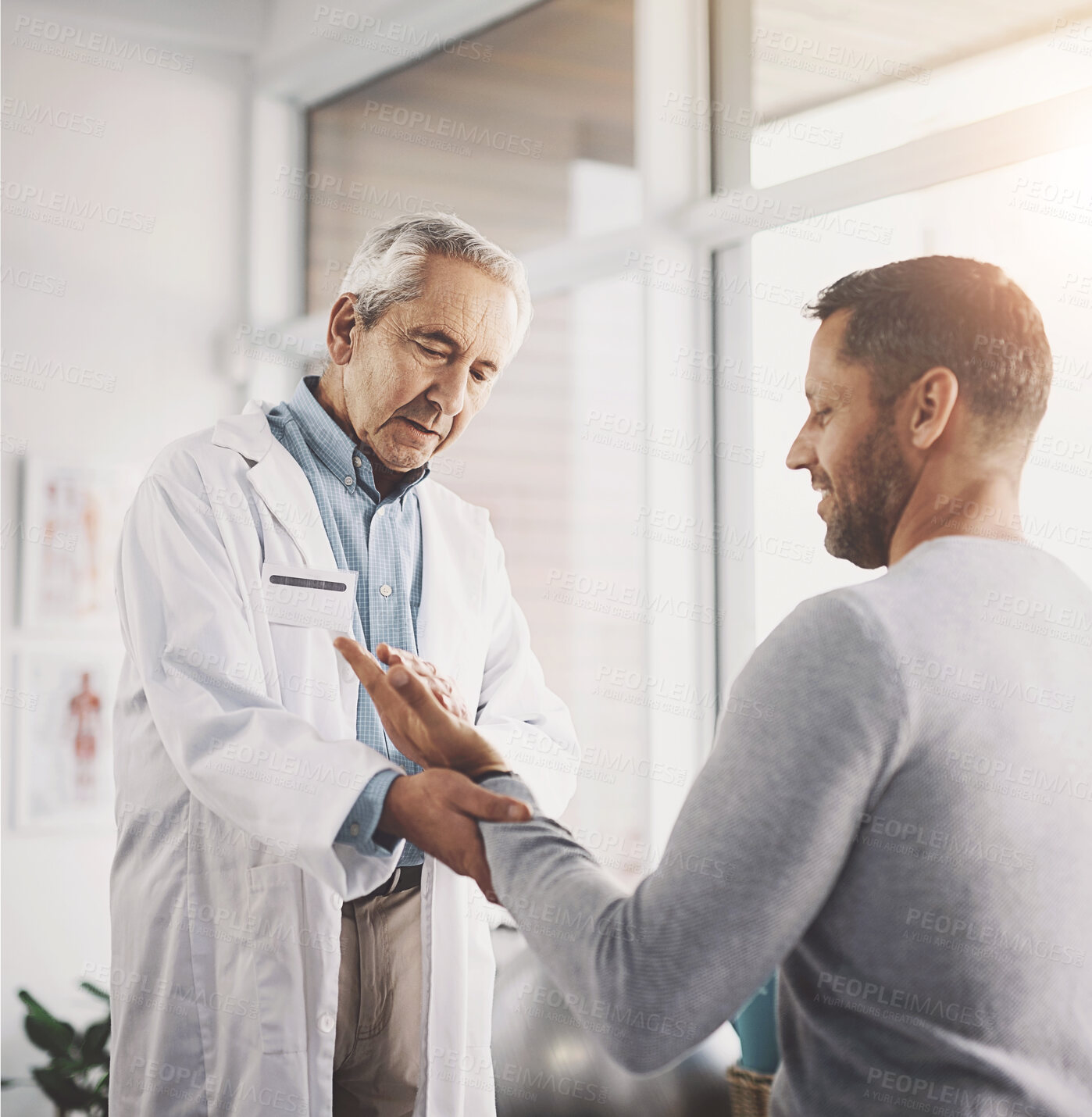 Buy stock photo Man, patient and doctor for hand inspection of wrist checkup, arthritis and exam for diagnosis assessment. Medical, people and joint pain from accident, nerve problem and healing arm for wellness