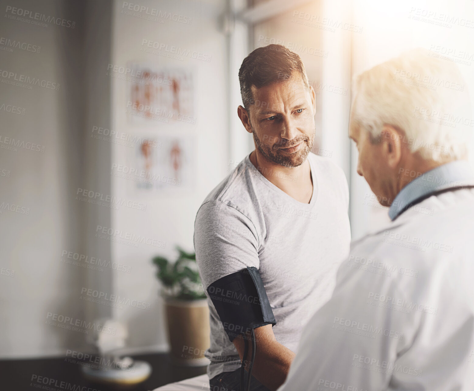 Buy stock photo Doctor, patient and man for blood pressure in consultation with test for hypertension and clinic with wellness check. Medical professional, person and healthcare for vital signs and health assessment