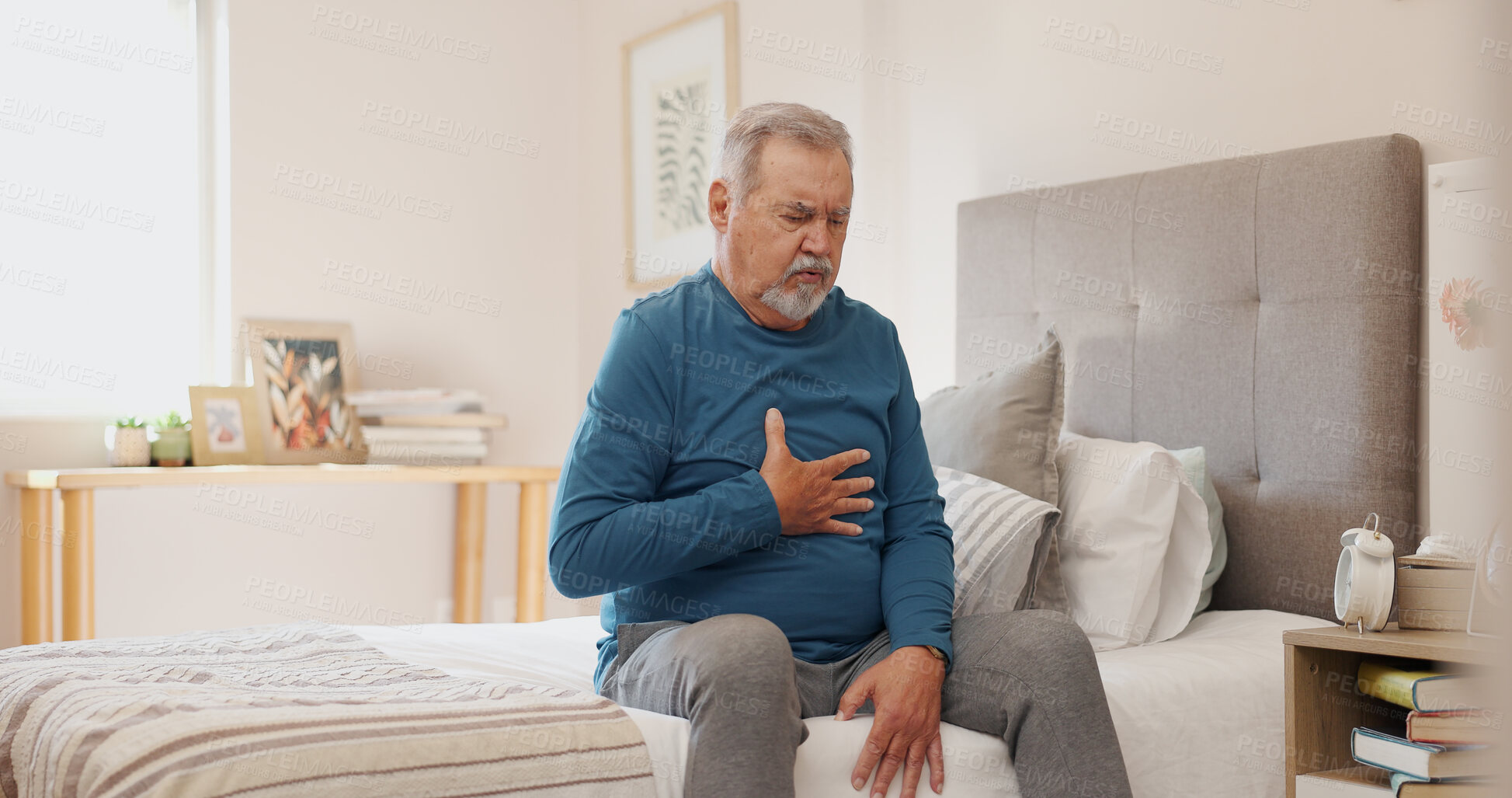 Buy stock photo Senior man, chest pain and injury with heart condition or panic attack in bed at home. Elderly male person with ache, sore body or cardiac arrest in stress, anxiety or health in bedroom at house