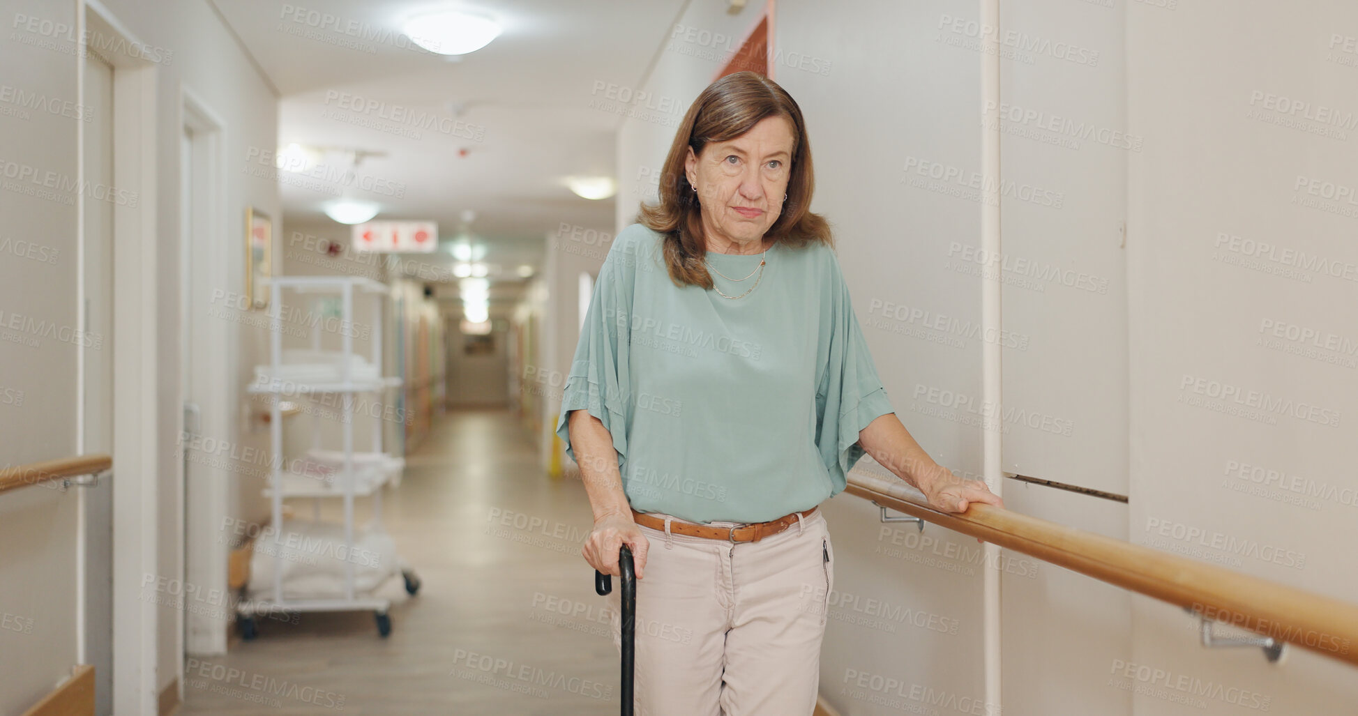 Buy stock photo Cane, walking and senior woman with disability in hospital for appointment, checkup and visit in hallway. Healthcare, corridor and female patient in clinic for help, assistance and care after injury