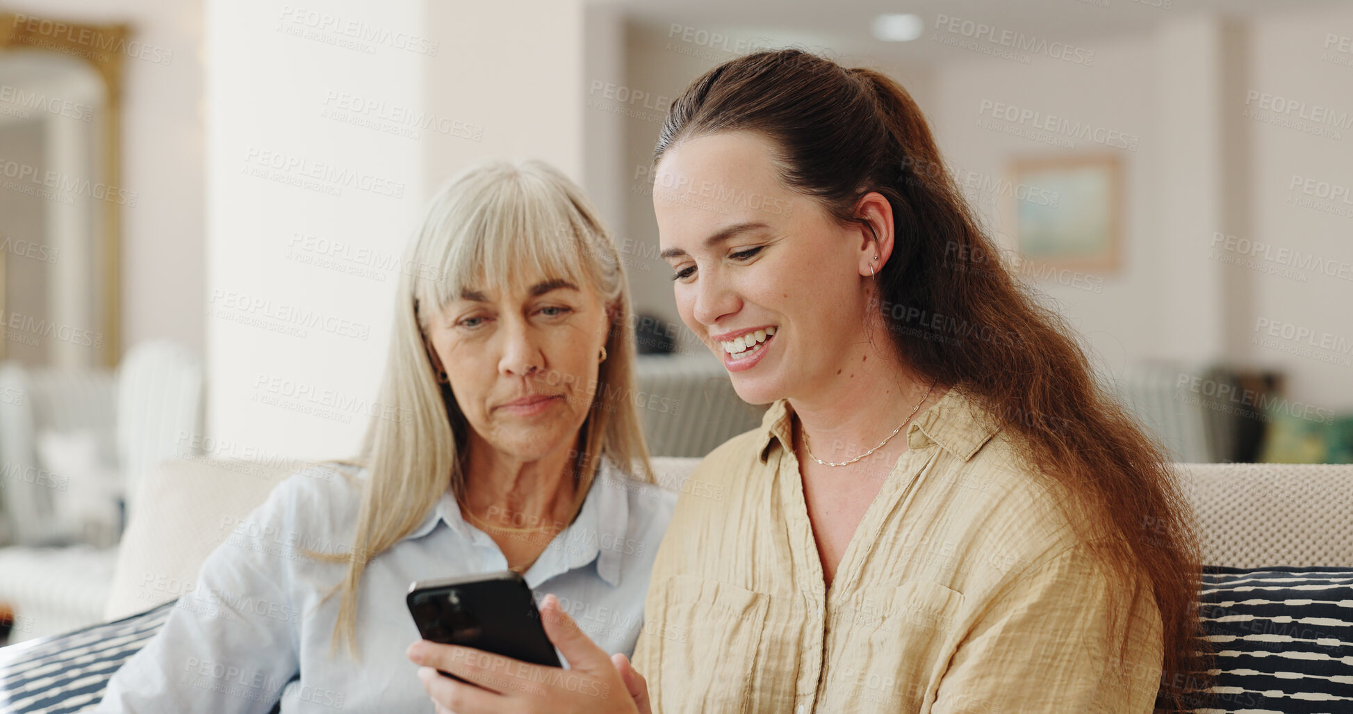 Buy stock photo Happy, senior mom and daughter with smartphone on sofa for teaching, learning and support with care. Living room, couch and smile with browsing internet for entertainment and games at old age home