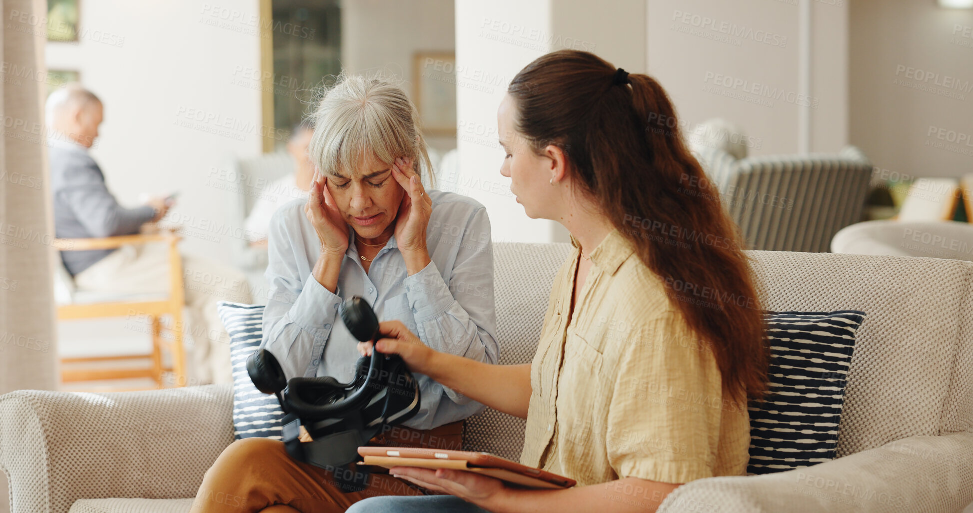 Buy stock photo Senior woman, headache and virtual reality on couch with tablet for test, metaverse and caregiver in retirement home. Geriatric psychiatrist, ar vision and tired with pain in exam for dementia on app