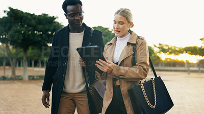 Buy stock photo Partner, people and walking with tablet outdoor for commuting to work, discussion and online schedule. Happy, coworker and smile with career chat, networking and communication at park in New York