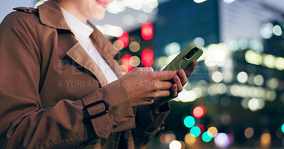 Buy stock photo Woman, hands and outdoor with texting on smartphone on smile at night for conversation on social media in New York. Female person, happy and text message for networking or communication on mobile app