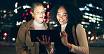 City, women and discussion with tablet at night for creative planning, website and outdoor travel to work. Happy, friends and smile with tech in street for journey, communication or email of feedback