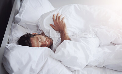 Buy stock photo Sleeping, tired and man in bed in home for relaxing on weekend morning with dreaming in rem. Fatigue, snooze and male person with pillow and blanket for resting afternoon nap in bedroom at apartment.