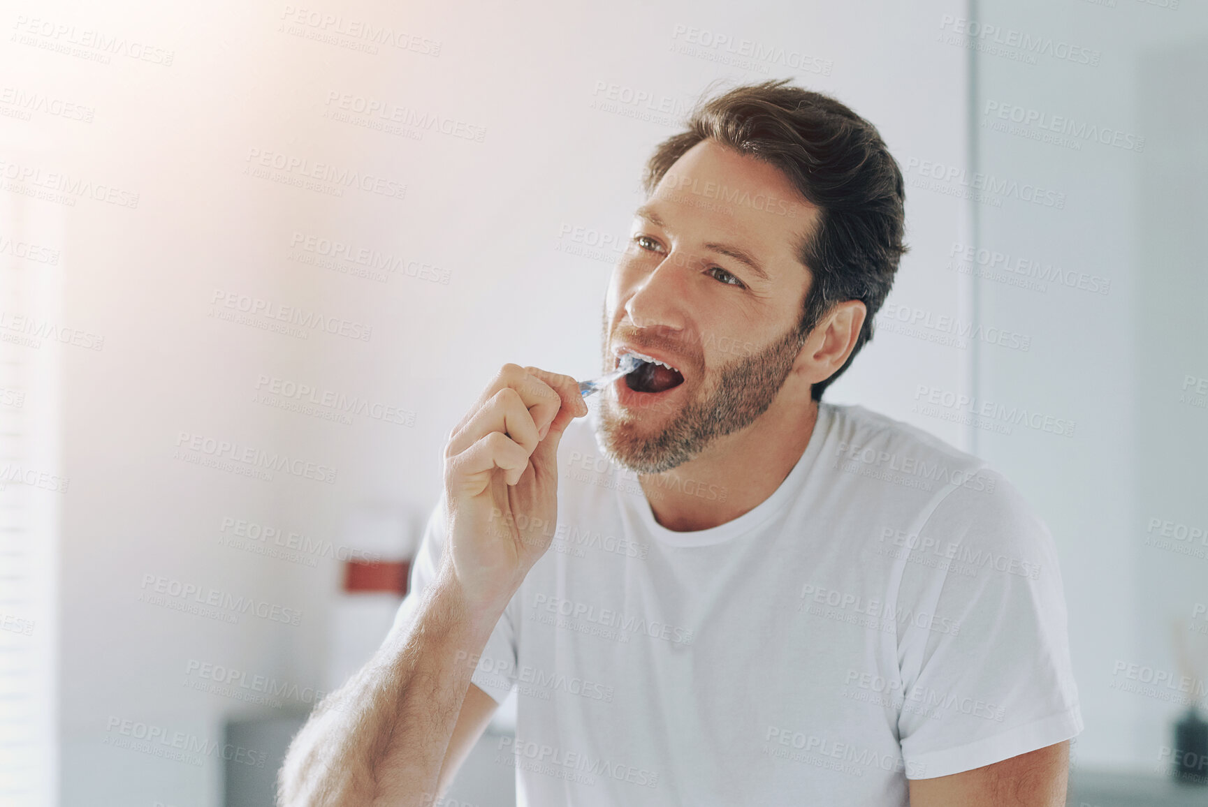 Buy stock photo Oral care, man or brushing teeth in bathroom for hygiene, whitening or routine clean in morning. Male homeowner, dental wellness and wash mouth at home for fresh breath, confidence or ready for work