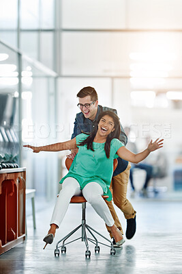 Buy stock photo Office, celebration or business employee push chair for happiness, investment growth or startup success in company workspace. Woman, fun and people with excited face for playing, achievement and win