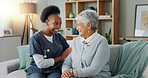 Happy face, nurse and elderly patient in nursing home for healthcare and volunteer with charity on sofa. African caregiver, portrait and embrace a senior lady with trust and medical support on couch