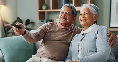 Buy stock photo Senior, couple and watching tv in home to relax with happiness on vacation or holiday in retirement. Elderly, man and woman hug on sofa and click choice for streaming comedy movies, series or film