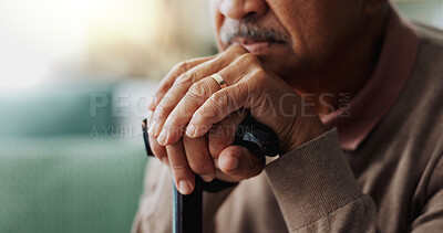 Old man, hands and walking stick in home for retirement grief for remember nostalgia, memory or thoughts. Male person, cane and wedding ring for elderly widower or unhappy, contemplating or lonely