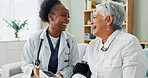 Elderly, woman and doctor with monitor for blood pressure with hypertension diagnosis, medical test and cardiovascular. Senior patient, nurse and laughing in nursing home for healthcare assessment