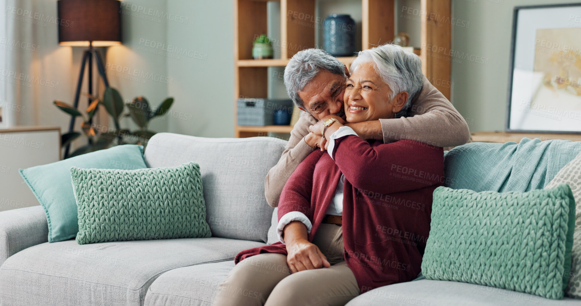 Buy stock photo Senior, couple and hug on couch with love for marriage, commitment and safety with security on weekend break. Man, woman and together on sofa for bonding with comfort, close and trust with romance.