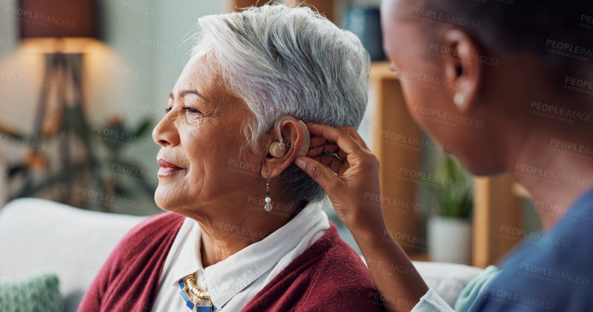 Buy stock photo Nurse, woman and hearing aid on ear for medical support, wellness and innovation of disability. People, healthcare worker and deaf patient with audiology implant, service or help for sound waves