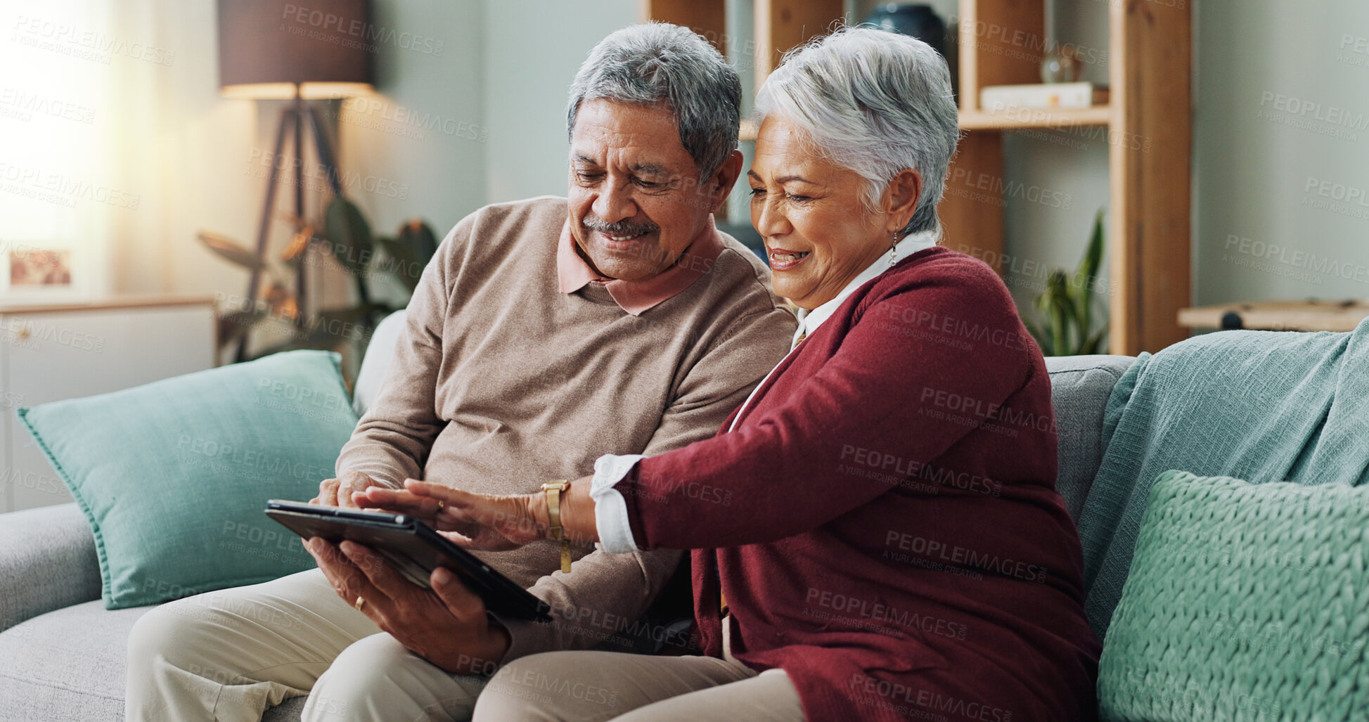 Buy stock photo Senior couple, happy and tablet for memories, streaming and communication in living room. People, mature man and woman on sofa, couch and house together in retirement with digital technology