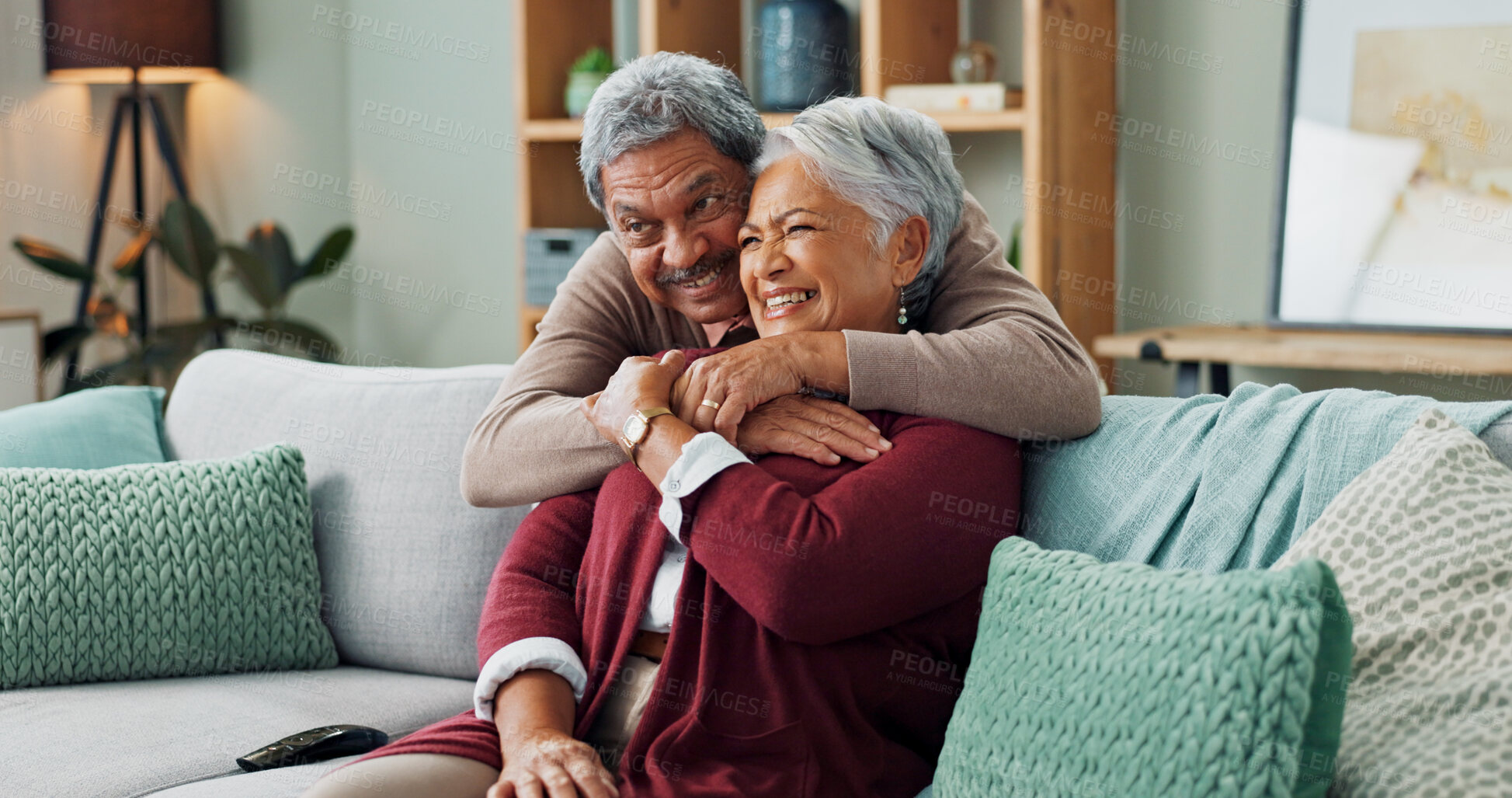 Buy stock photo Senior, couple and hug on couch with love for marriage, commitment and safety with security on weekend break. Man, woman and together on sofa for bonding with comfort, close and trust with romance.