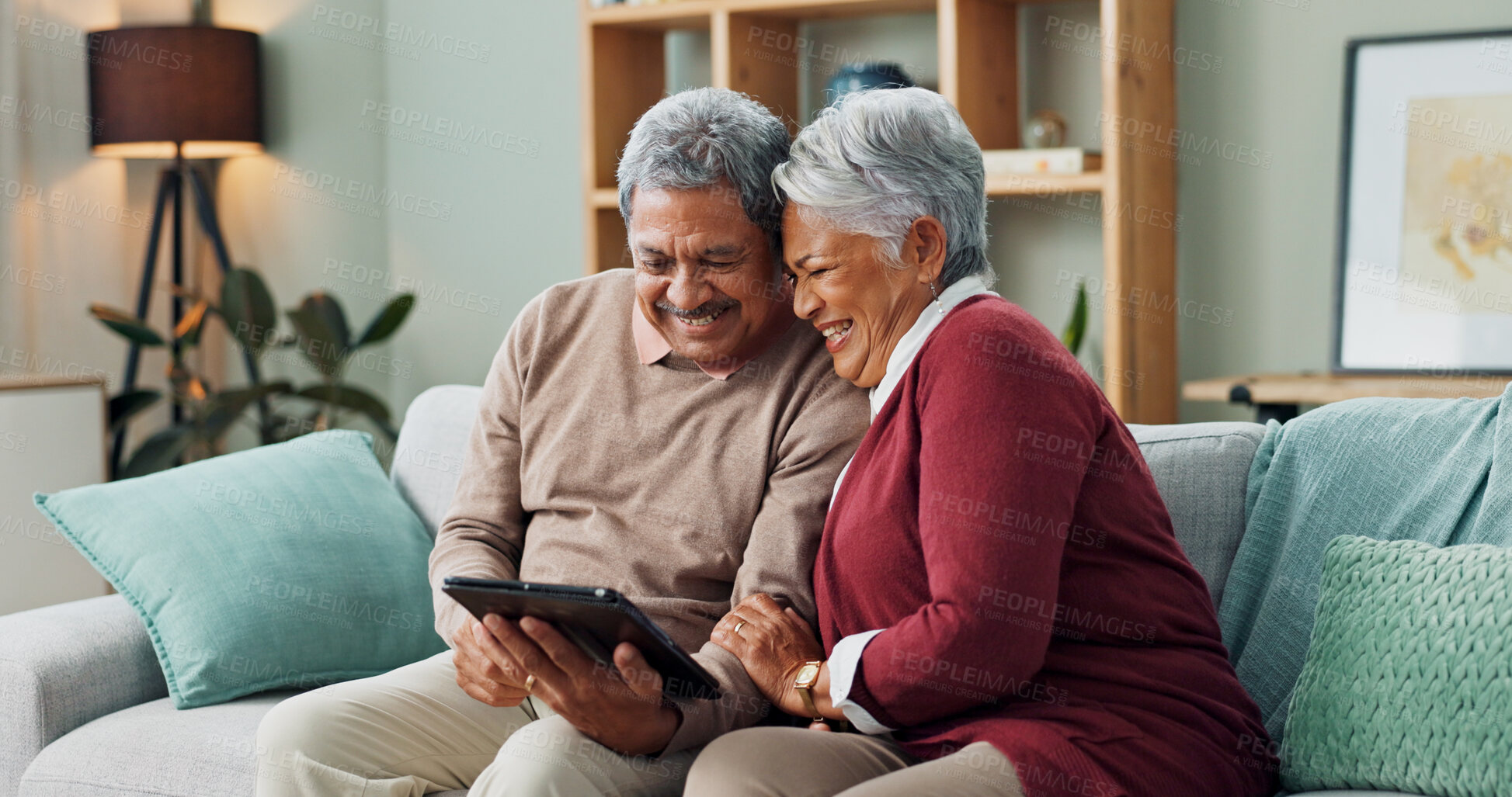 Buy stock photo Senior couple, happy and laughing with tablet, streaming and communication in living room. People, mature man and woman on funny meme, couch and house together in retirement with digital technology