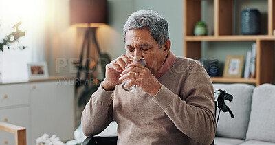 Senior man, wheelchair and drinking water in home with depression, sick or stress in retirement. Glass, house and elderly person with a disability, disease or frustrated with parkinson in living room