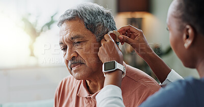Nurse, patient and hearing aid on ear for medical support, wellness and innovation of disability. People, healthcare worker and deaf man with audiology implant, service or help for sound waves