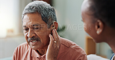 Nurse, man and hearing aid on ear for medical support, wellness and innovation of disability. People, healthcare worker and deaf patient with audiology implant, service or help for sound waves