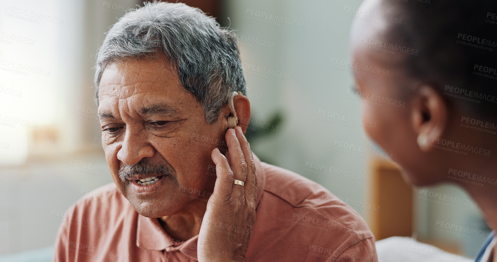 Buy stock photo Nurse, man and hearing aid on ear for medical support, wellness and innovation of disability. People, healthcare worker and deaf patient with audiology implant, service or help for sound waves