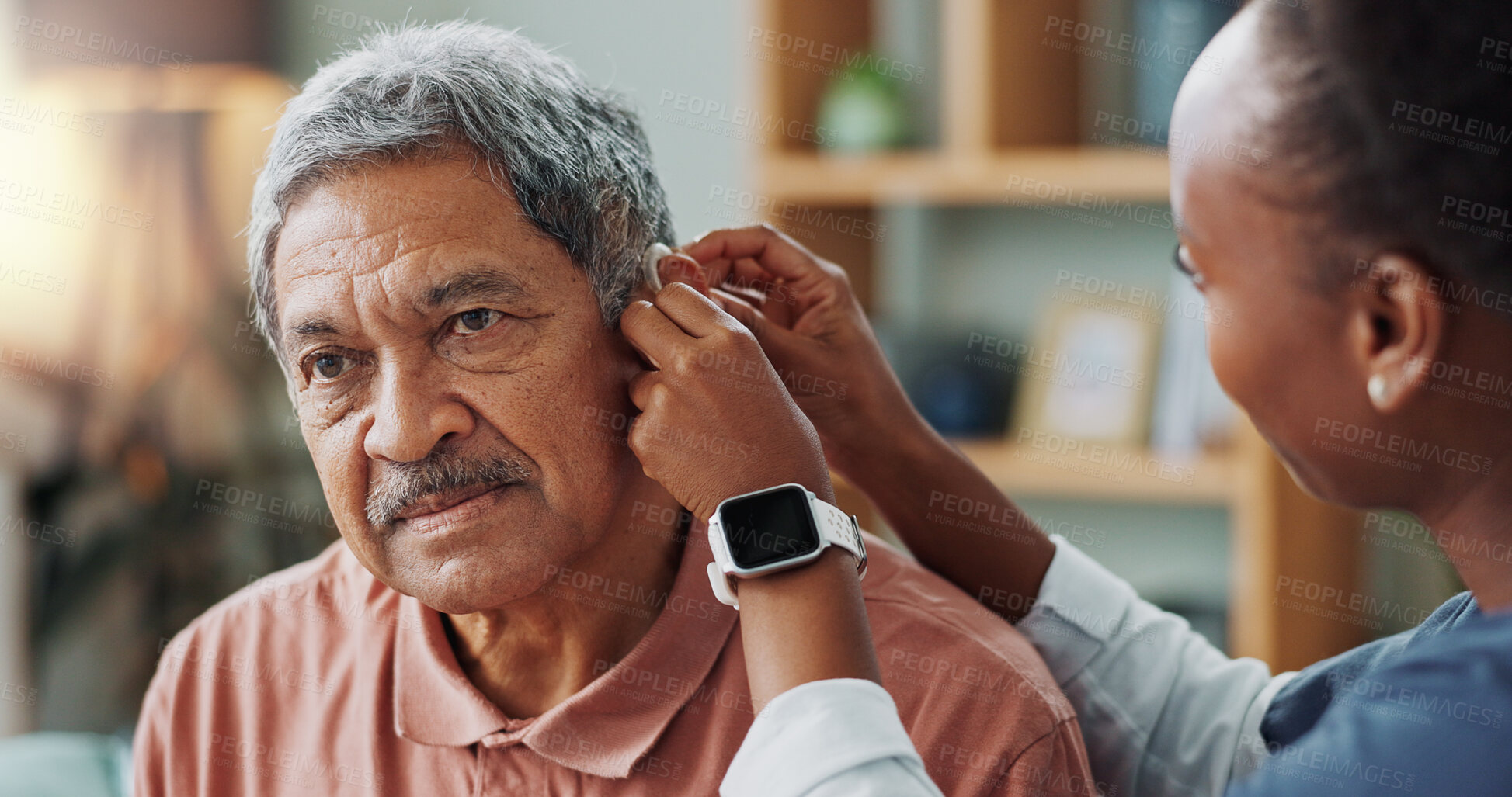 Buy stock photo Nurse, patient and hearing aid on ear for medical support, wellness or innovation of disability. People, healthcare worker or deaf man with audiology implant, check and service or help for sound wave