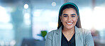 Face, smile and a confident business indian woman in her office at work looking happy with her corporate career. Portrait, success and ambition with a young professional employee in the workplace