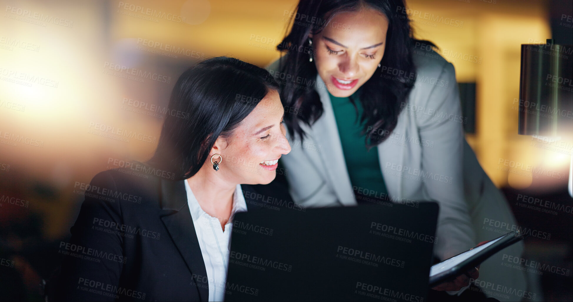 Buy stock photo Laptop, tablet and collaboration with business people at night in the office together for teamwork. Technology, smile and a happy employee team of women working on a project or report in the evening