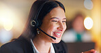 Woman, telemarketing and consulting at night in office for customer service, CRM advisory and funny communication. Face, agent and laugh in call center for telecom support, FAQ contact and questions