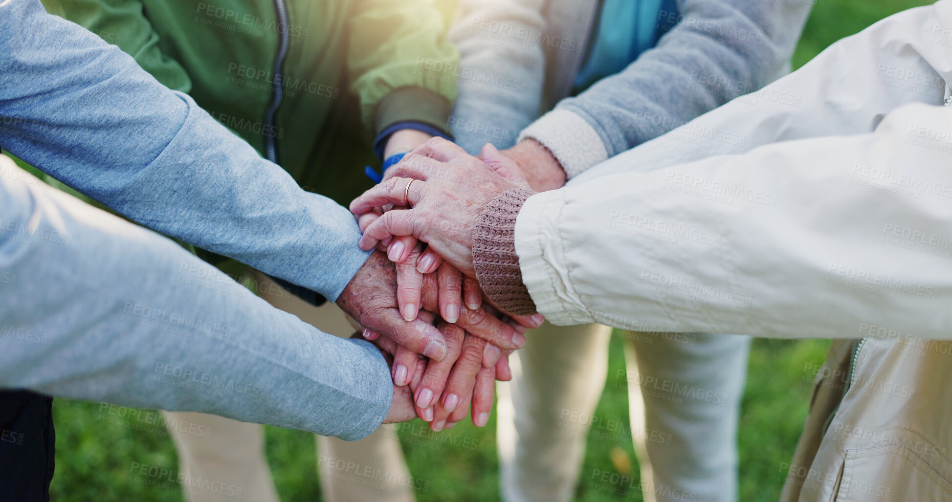 Buy stock photo Elderly people, hands together and teamwork for community, trust or support together in nature. Mature or retired group piling in team building, collaboration or motivation for goals at outdoor park