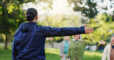 Woman, personal trainer and stretching in nature for elderly care, workout or outdoor exercise. Rear view of female person, coach or instructor training mature group of people at park for fitness
