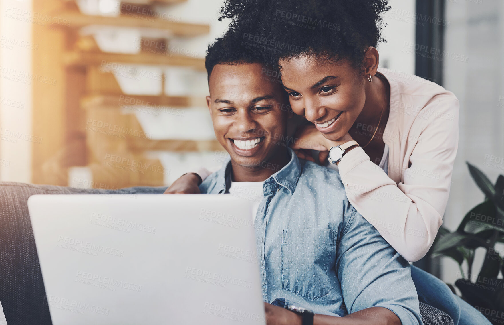 Buy stock photo Black couple, hug and happy with laptop in home for remote work, reading email or scrolling social media on sofa. People, embrace and technology in living room for online browsing and watching movie