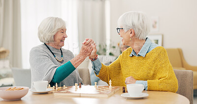 Senior woman, friends and high five for chess match, game or winning on table together at home. Happy elderly women in celebration, playing strategic board game for victory or checkmate in retirement