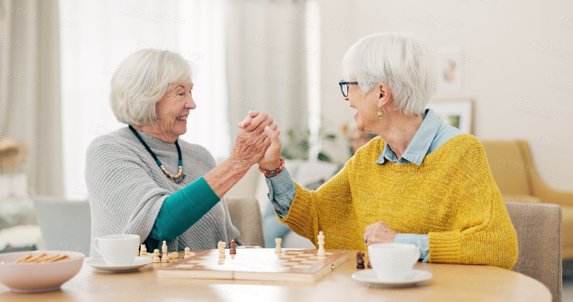 Buy stock photo Senior woman, friends and high five for chess match, game or winning on table together at home. Happy elderly women in celebration, playing strategic board game for victory or checkmate in retirement