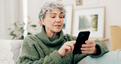 Senior woman, phone and typing for social media, online browsing or scrolling on living room sofa at home. Happy elderly female person busy on mobile smartphone app for streaming or entertainment