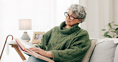 Buy stock photo Senior woman, sofa and reading book in living room for story, novel and knowledge. Elderly female person relax with books in lounge for retirement break, literature or hobby to enjoy on couch at home