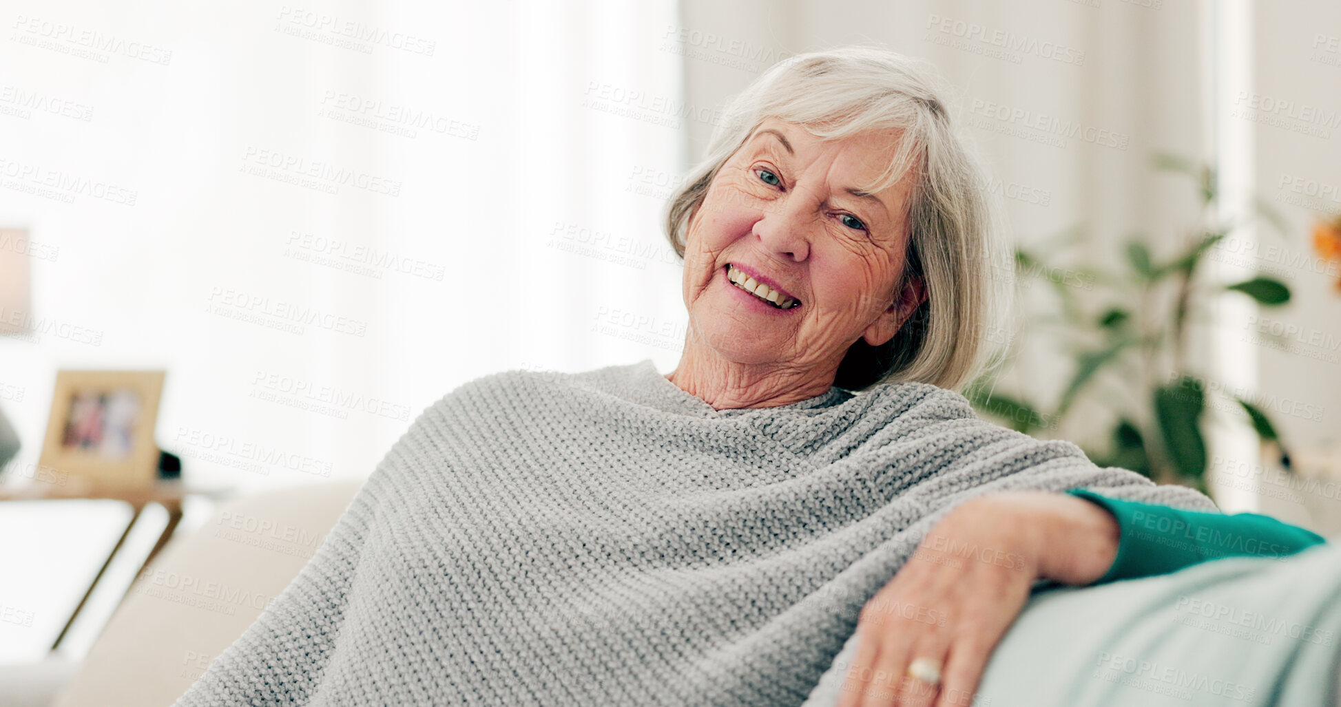 Buy stock photo Face, funny and senior woman on couch, home and happiness with retirement, relax and cheerful. Portrait, elderly lady and female person on a sofa, laughing and humor with joy, apartment and peace