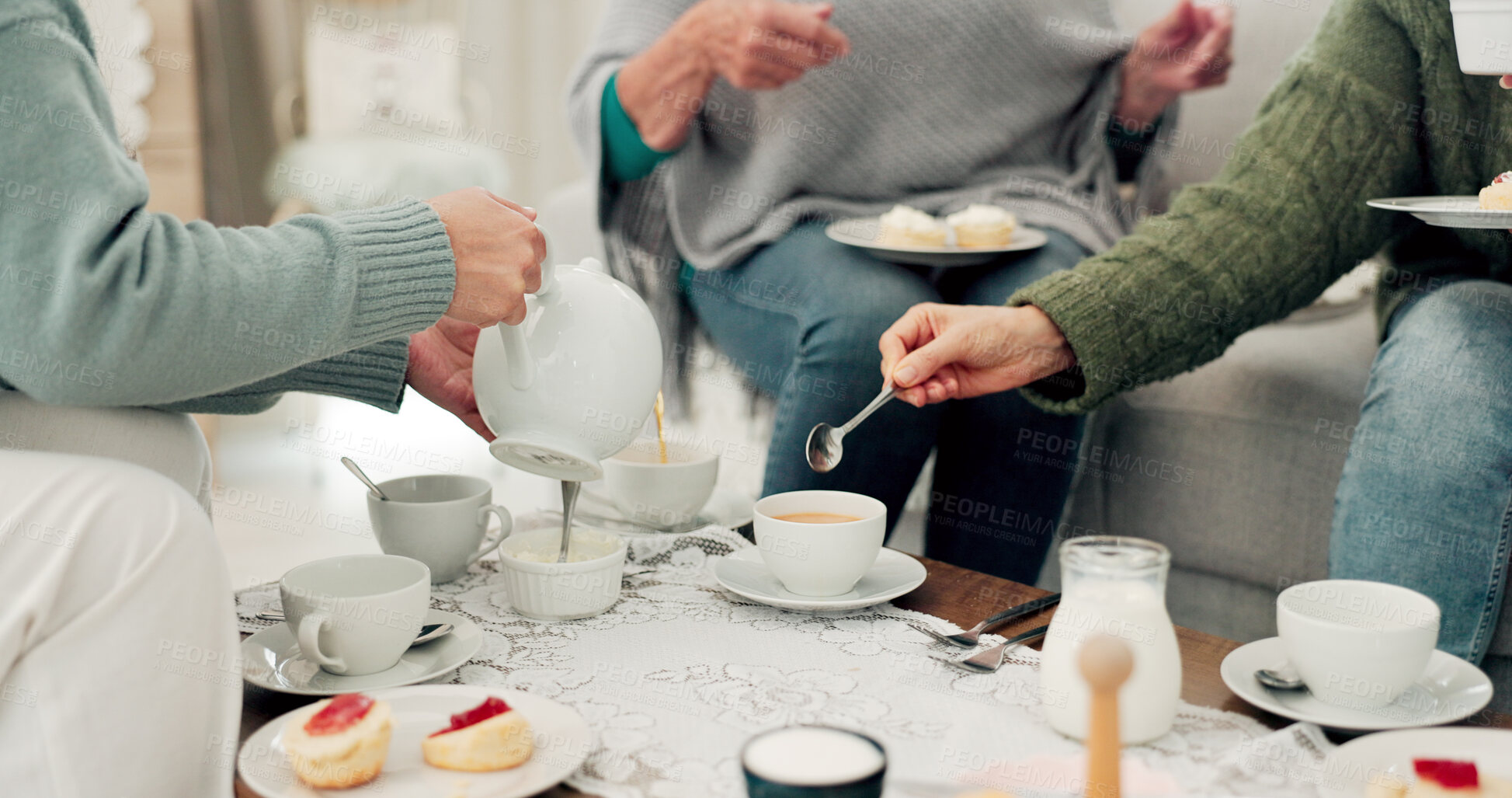 Buy stock photo Hands, tea party and senior friends in the living room of their home together for a visit during retirement. Wellness, relax and reunion with a group of elderly people sitting on a sofa in a house