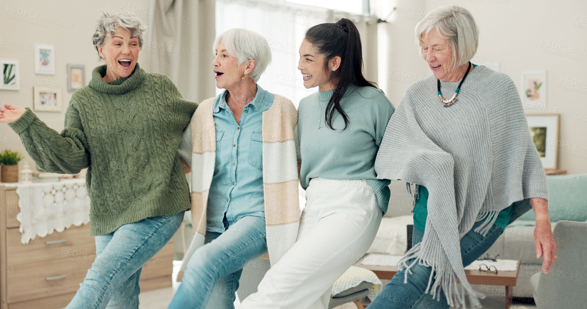 Buy stock photo Dance, high five and senior women with a nurse in the living room of their retirement home together. Healthcare, wellness and fun with a group of people laughing while bonding together in a house