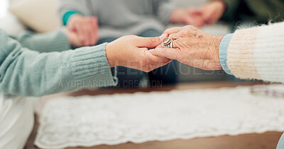 Woman, holding hands and support group for elderly care or trust for unity, community or social gathering at home. Closeup of women touching hand in teamwork activity, understanding or collaboration