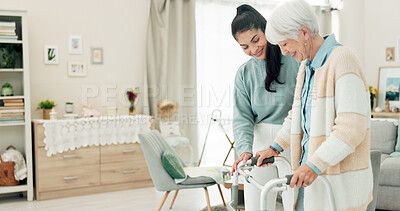 Buy stock photo Woman, nurse and walker in elderly care for physiotherapy, support or trust at old age home. Female physio or caregiver walking and helping patient or person with a disability for recovery in house