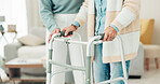 Woman, hands and walker in elderly care for physiotherapy, support or trust at old age home. Closeup of female nurse or caregiver walking and helping patient or person with a disability in the house