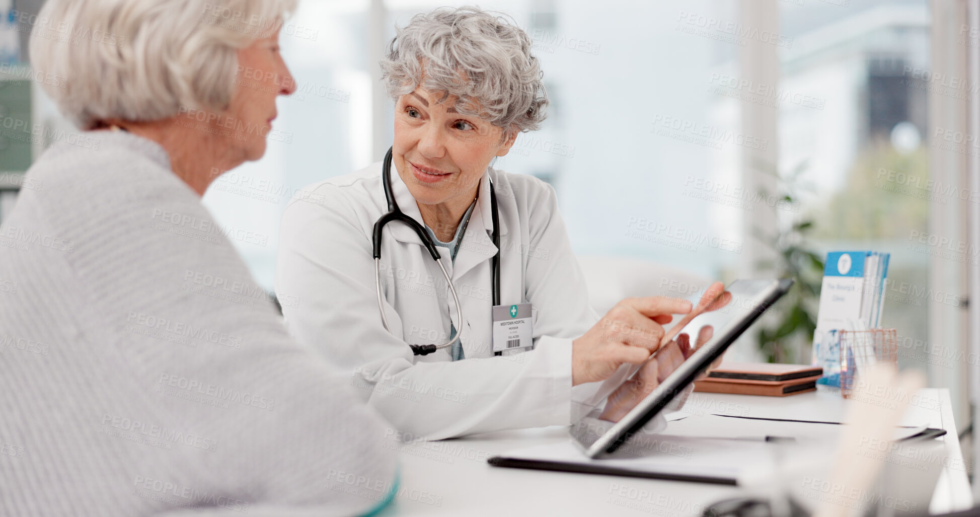 Buy stock photo Senior doctor, tablet and talking to patient for healthcare prescription or diagnosis at hospital. Mature medical professional consulting elderly female person on technology for help advice at clinic
